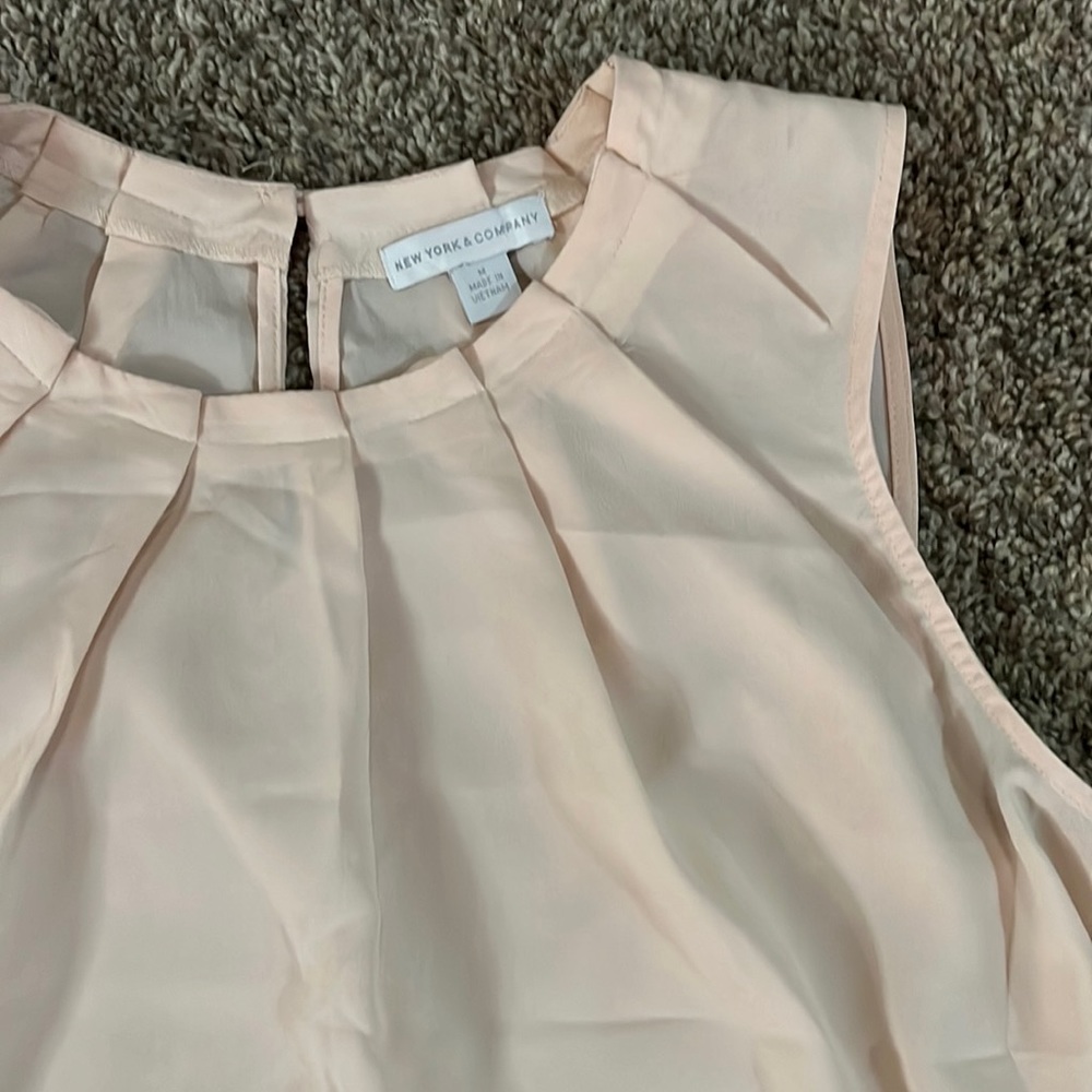 Pale pink sleeveless blouse